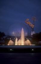 Walt Disney World Epcot. View of the Spaceship Earth with  Epcot sign and fountain illuminated at dusk. **Editorial Use Only**