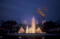 Walt Disney World Epcot. View of the Spaceship Earth with  Epcot sign and fountain illuminated at dusk. **Editorial Use Only**