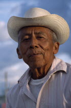 Smiling  elderly men in hat  head and shoulders portrait.