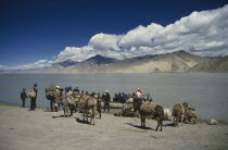 People with laden donkeys boarding a ferry to cross the Tsangpo river