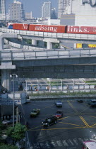 Sky Train above pedestrian walkways and road traffic at the junction of Rama 1 and Phaya Thai Road