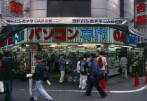 Electrical store open to the street with people walking past