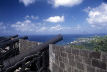 View of coastline from the top of the fortified wall with line of cannons.