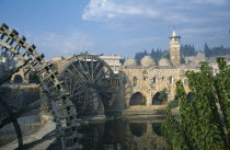 Wooden norias or waterwheels on the Orontes river and the Al-Nuri Mosque dating from 1172 and built of limestone and basalt.