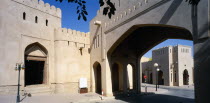 Town centre with crenellated walls and archway over empty street.