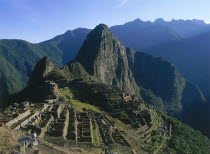 Peru, Cusco Department, Machu Picchu, view looking across ruins towards surrounding mountains.