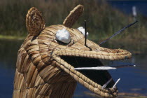 Detail of the prow of a reedboat  the lake beyond.