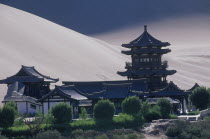 Silk Route with a Buddhist Temple and sand dunes beyond