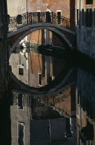 Small bridge over canal reflected in waterEuropean Italia Italian Southern Europe