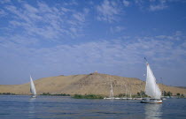 Qubbet el-Hawa and The Tombs of The Nobles with two feluccas sailing past on the river Nile