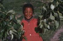 Tibetan girl holding tree branches