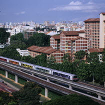 MRT Mass Rapid Transport train with City Skyline and apartment blocks