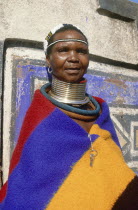 Portrait of an Ndebele woman in traditional dress and wearing a large necklace at Botshabelo near Middelburg