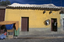 House with telephone & stall in front