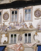 Close up of Bavarian wall paintings around the windows of a building