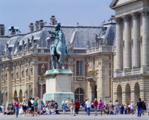 Palace forecourt and equestrian statue with tourist visitors