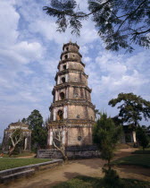 Thien Mu Pagoda tiered brickwork mottled sky overhanging branch