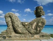 Chac-Mool statue with the sea beyond