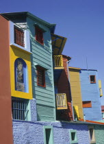 Detail of brightly coloured wooden buildings set against a deep blue sky