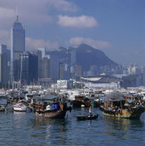 Typhoon Shelter with Sampans and Junks with Wanchai skyline beyond