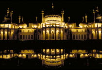 The Royal Pavilion illuminated at night and reflected in the lilly pond European Great Britain Nite Northern Europe UK United Kingdom British Isles History Pavillion