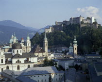 Hohensalzburg Fortress on wooded hill beyond the city rooftops