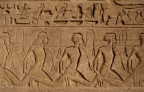 Hieroglyphics above relief carving of Nubian slaves