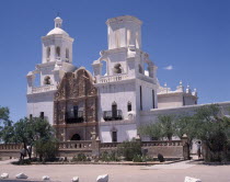 San Xavier del Bac Mission. White-washed building with  towers an ornate entrance and balconies