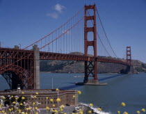 Golden Gate Bridge General view with fort below and hills in the background.