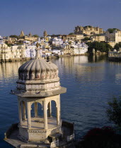 City view over Lake Pichola with ornate tower in the foreground