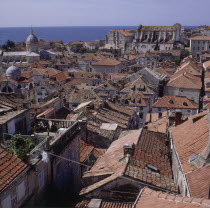 View over rooftops of the city with the sea beyond