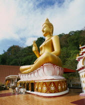 Big Buddha Temple.  Large seated golden Buddha figure in temple courtyard.Andaman Coast