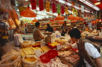 Wanchi market interior with display of variety of food products  customers and staff.