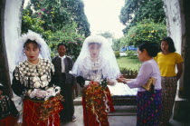 Jinghpaw wedding with Bride and bridesmaid entering the Geis memorial churchBurma Myanmar