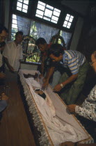 Jinghpaw funeral with the deceased in a coffin at the families homeBurma Myanmar