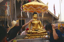 Sihing Buddha statue being bathed with lustral water