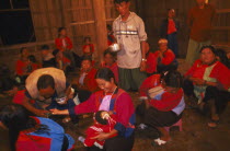 Lisu shaman spraying supplicants hand at healing ceremony