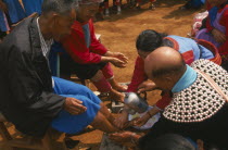 New Year. People paying respects to their elders by putting new socks on their feet