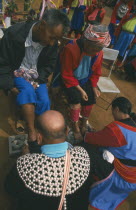 New Year. People paying respects to their elders by putting new socks on their feet