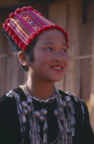 Portrait of a Jinghpaw girl wearing traditional womans jacket and hat