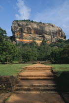 View along path toward huge monolithic rock site of fifth century citadel. Also called Lion Rock.