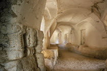 Passageway with carved pillars re-used as supports in the foreground. Ghadamis Gadames