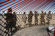 Communal erection of yurt for newly married couple as part of traditional wedding ceremony.Ger