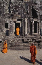 Bayon Temple with three monks taking photographs of each other on the top levelAsian Cambodian Kampuchea Religion Southeast Asia 3 History Kamphuchea Religious