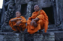 Bayon Temple with two monks sitting on the upper levelAsian Cambodian Kampuchea Religion Southeast Asia 2 History Kamphuchea Religious