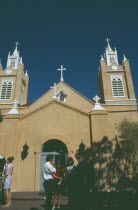 Tourists outside san Felipe de Neri church in the old town plaza