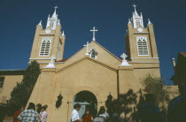 Tourists outside San Felipe de Neri church in the old town plaza