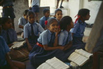 Pupils in uniform in classroom of village school.