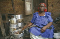 Woman cooking for large household.