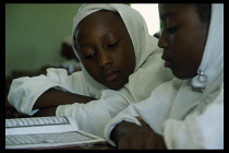 Primary school children reading a book